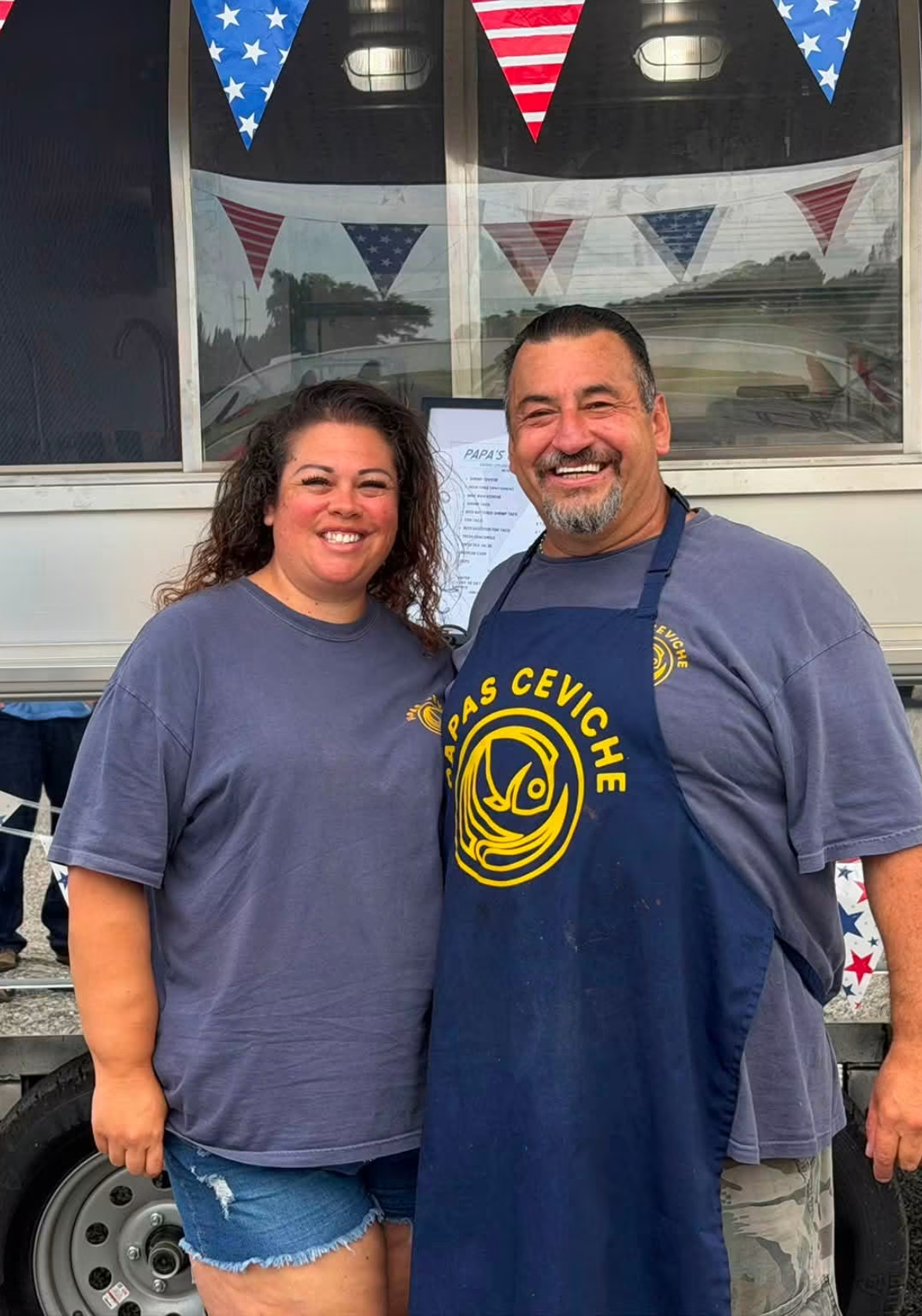 The Papas Ceviche owners standing in front of the food truck